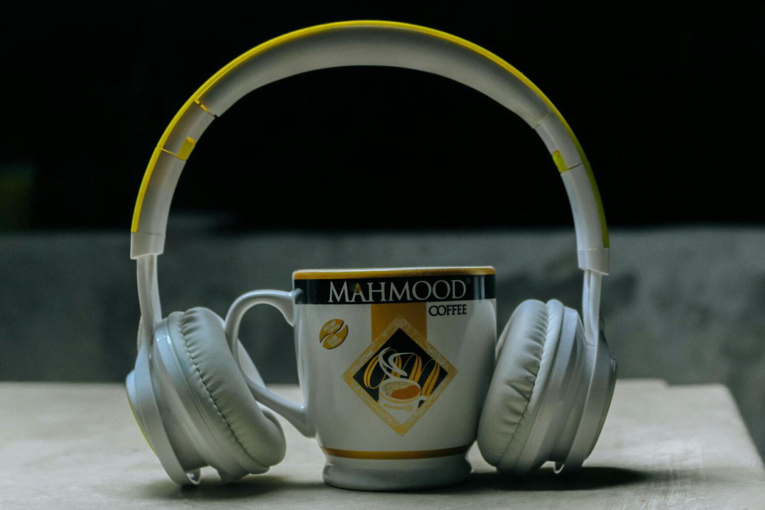 close up photography of headset near cup