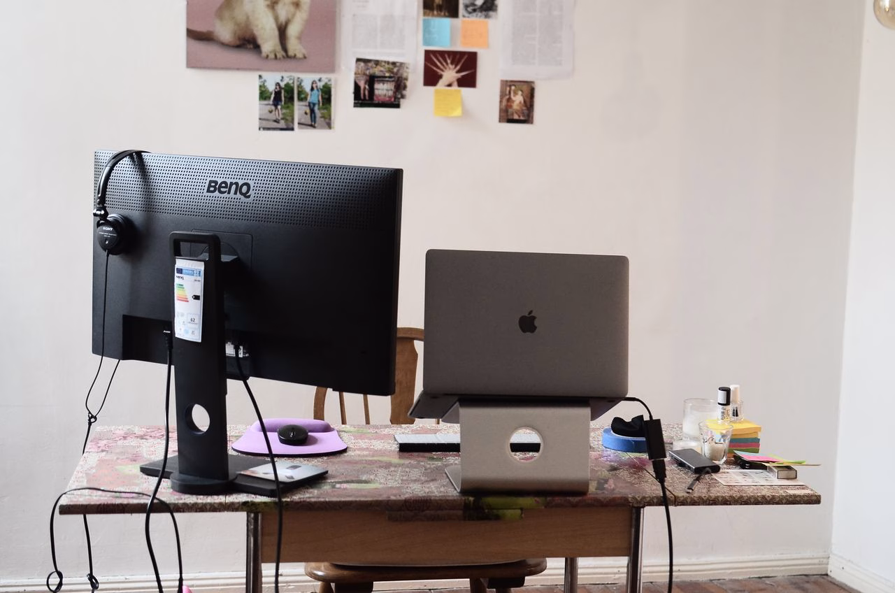 Hemma kontor med en Macbook och extra skärm sett bakifrån