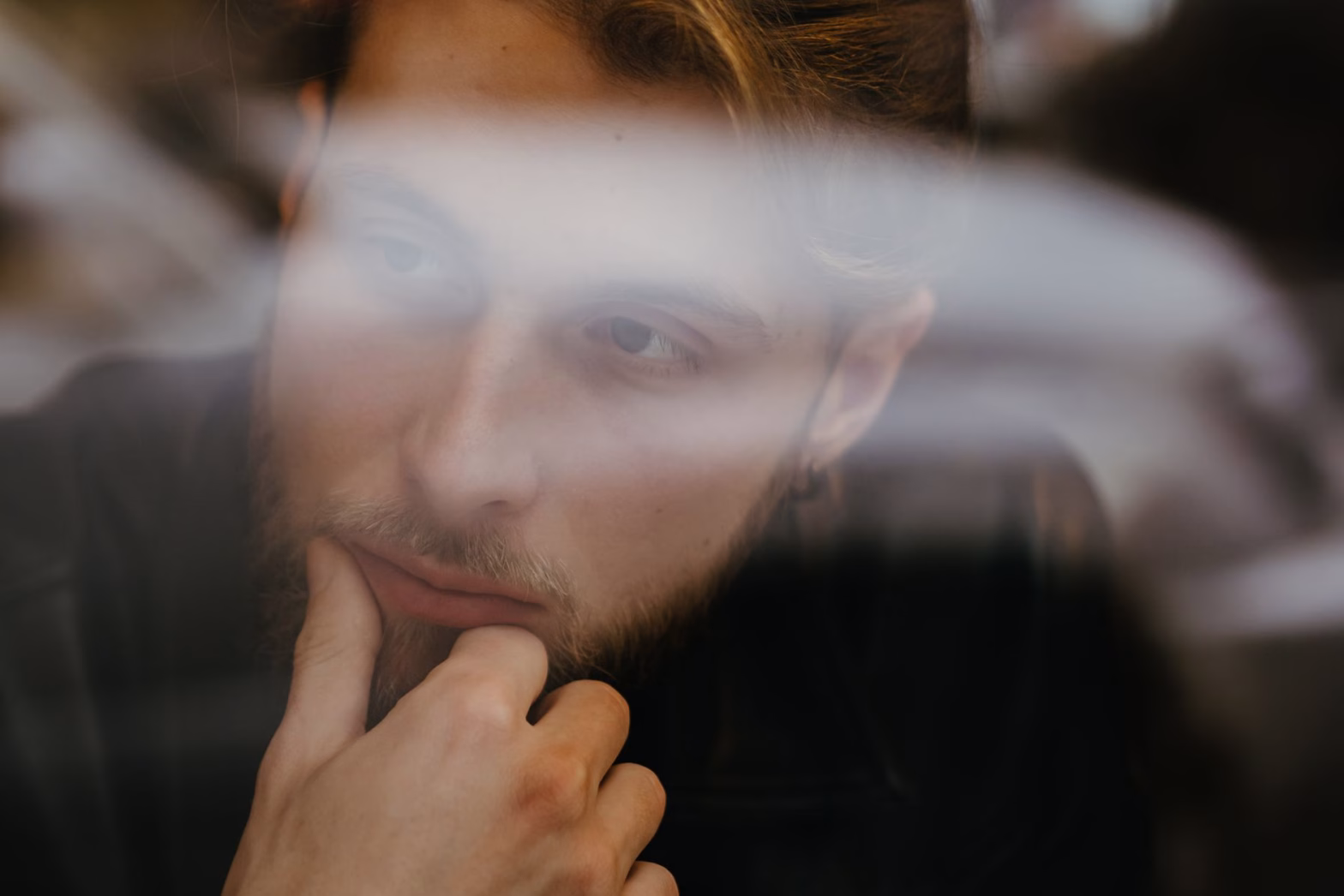 bearded man with hand on his chin